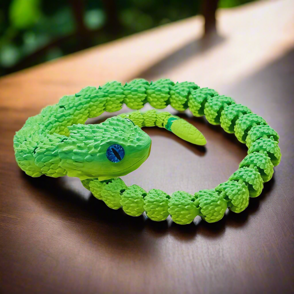 3D printed articulating copperhead snake toy in a loop, demonstrating its flexibility and detailed blue and yellow scales, 26 inches long.