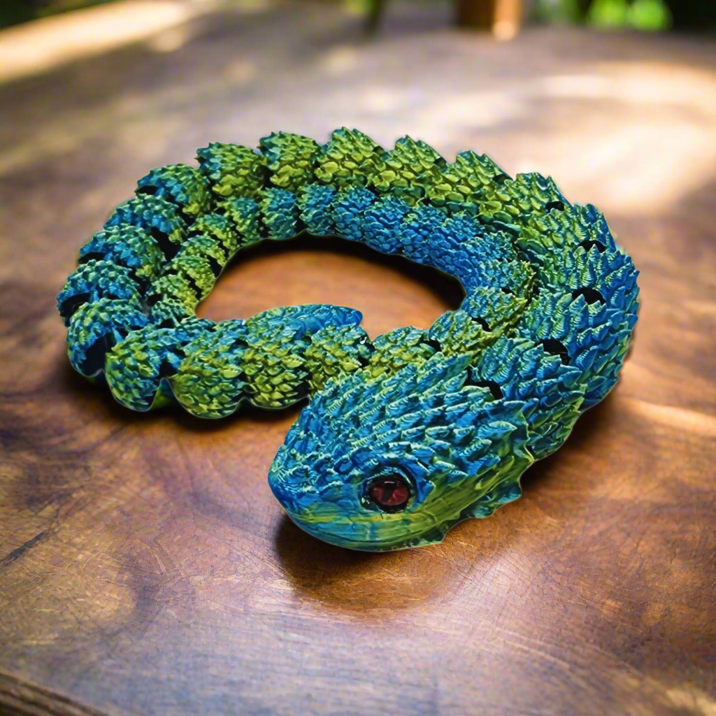 3D printed articulating copperhead snake toy in a loop, demonstrating its flexibility and detailed blue and yellow scales, 26 inches long.