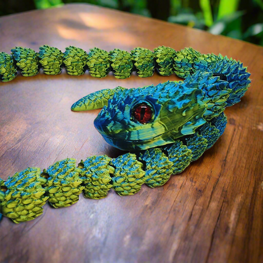 Front view of a 3D printed copperhead snake toy in blue and yellow, showcasing its realistic red eyes and articulated body, 26 inches long.