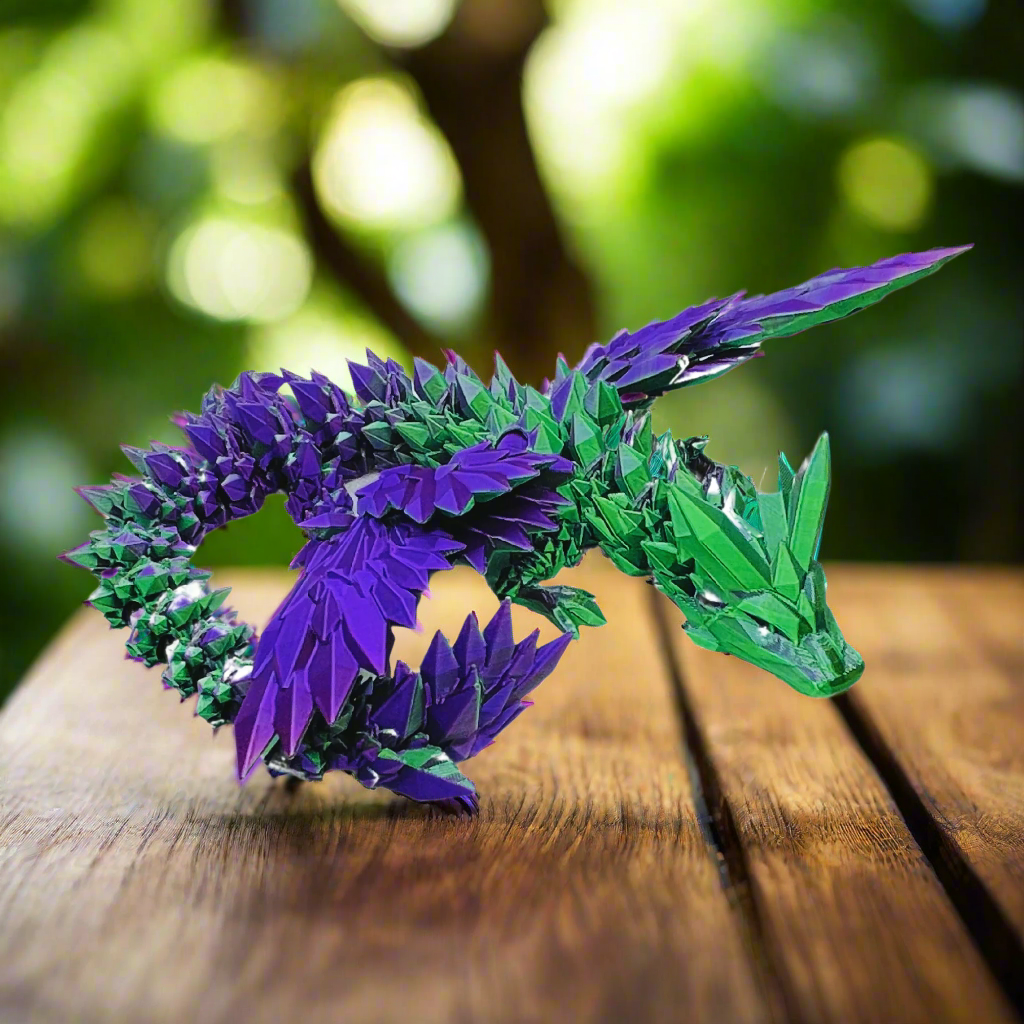 3D printed crystal-wing dragon toy in purple and green silk colors, shown in a coiled position with articulated joints, 20 inches long.