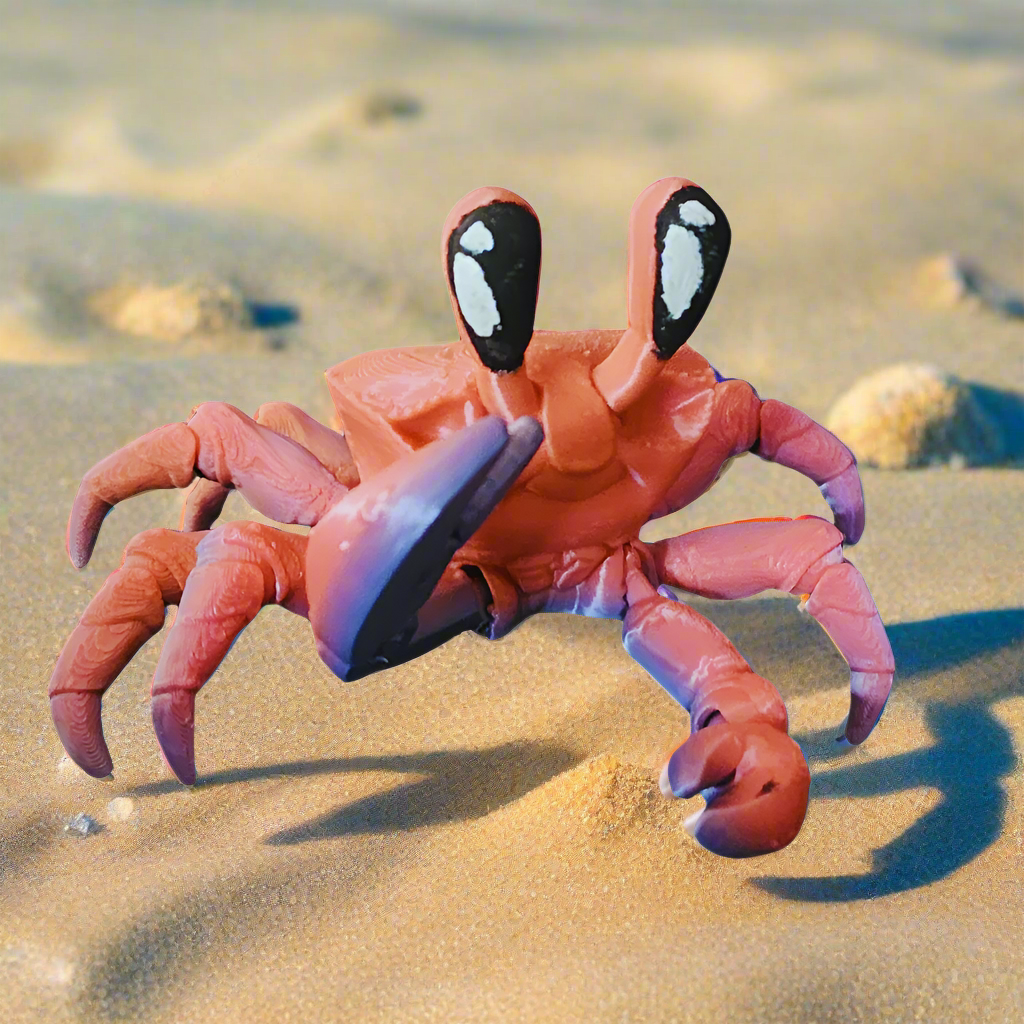 A side view of a vibrant 3D-printed articulated crab, showcasing its detailed legs and claws on a sandy surface. The crab is flexible and movable, making it an ideal fidget toy or display item.