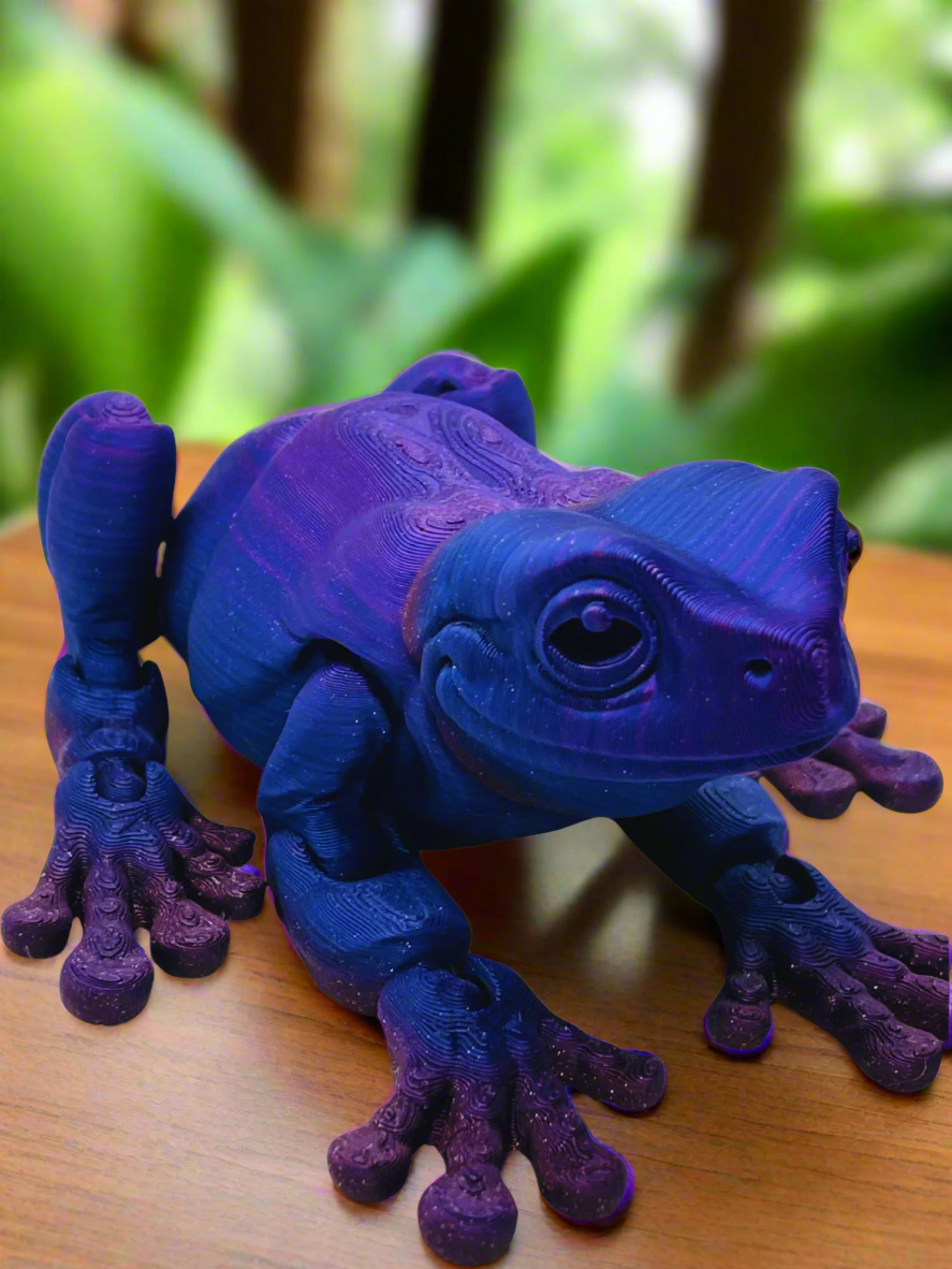 Side view of a 9-inch long 3D printed tree frog in blue and purple, showcasing its unique eyeless design and smooth features.