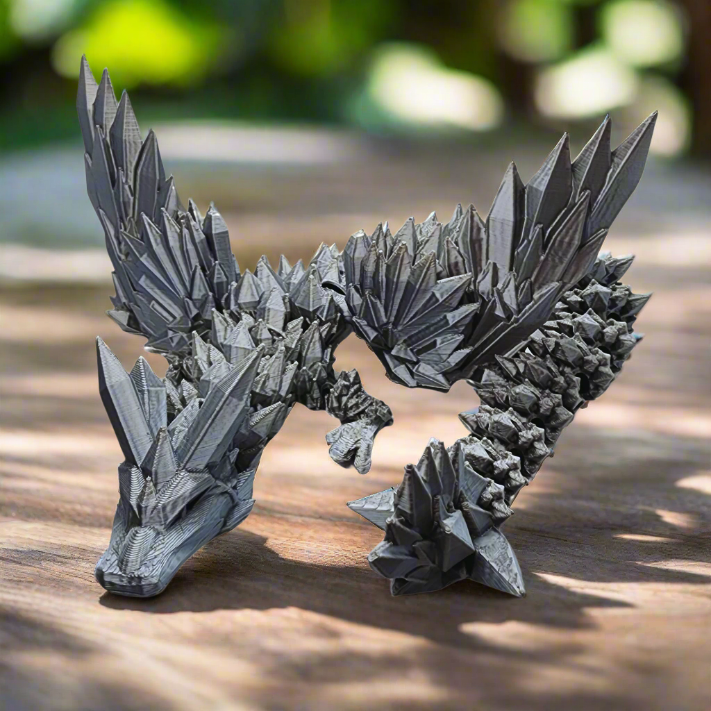 A front-facing view of the silver dragon figurine with wings spread wide, capturing its fierce and dynamic pose.
