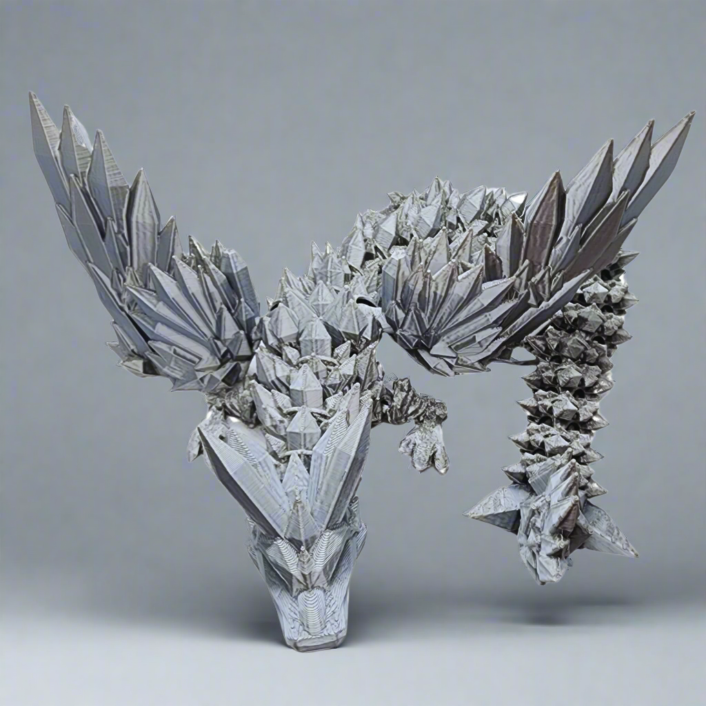 A full-body view of the silver dragon figurine, displaying its entire structure from head to tail in a natural, outdoor setting.