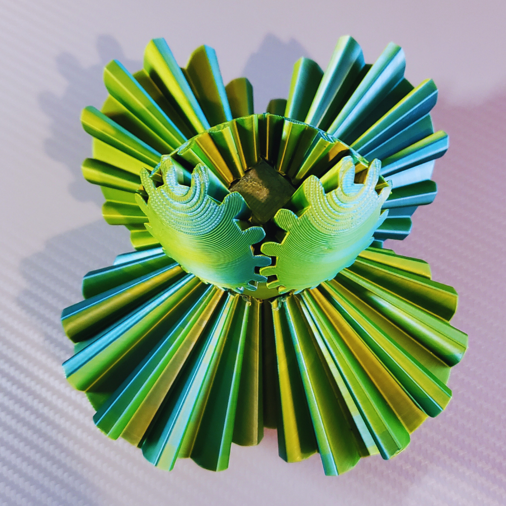 Top-down view of the Gear Sphere 3D Printed Fidget Toy, highlighting the intricate green and blue interlocking gear design. Perfect for stress relief, sensory engagement, and focus improvement.