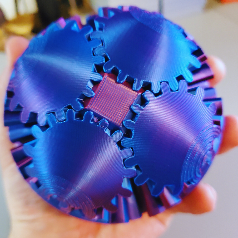 Handheld view of the Gear Sphere 3D Printed Fidget Toy, emphasizing the durable and visually appealing blue and purple design.